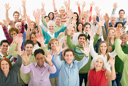 A crowd with their arms in the air